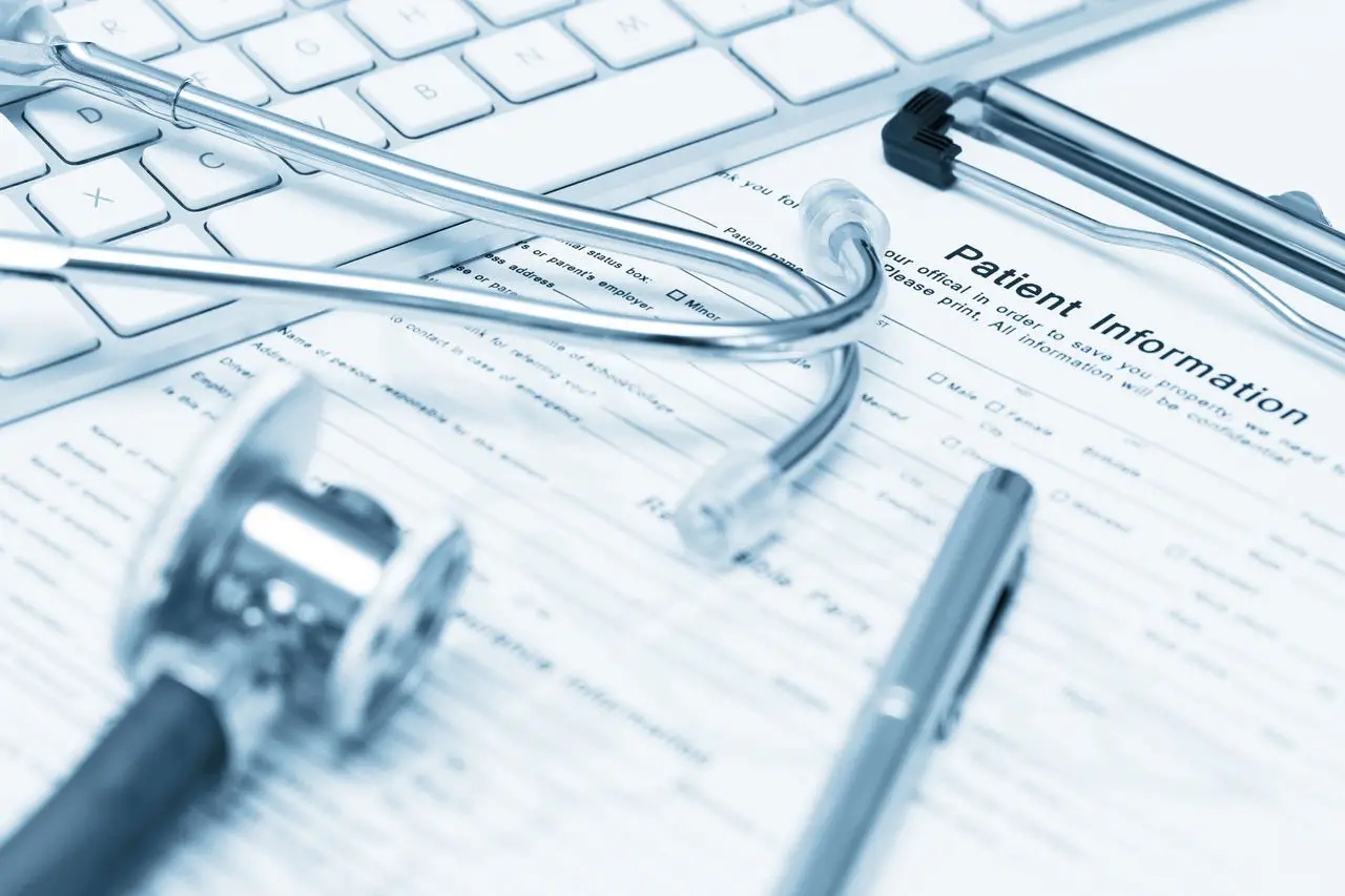 Patient record form, stethoscope and pen